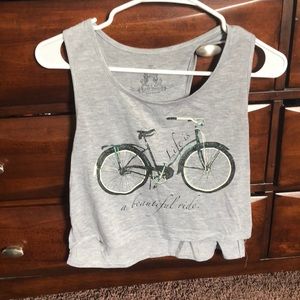 gray cropped tank top with bicycle and saying